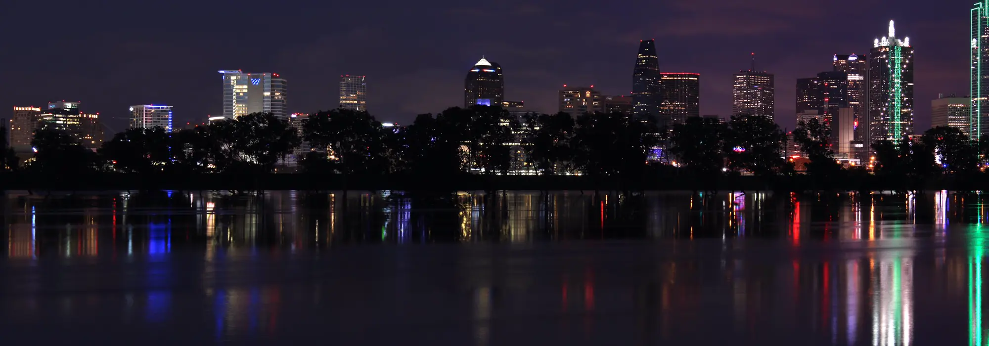 The Dallas skyline at dusk across the Trinity River.