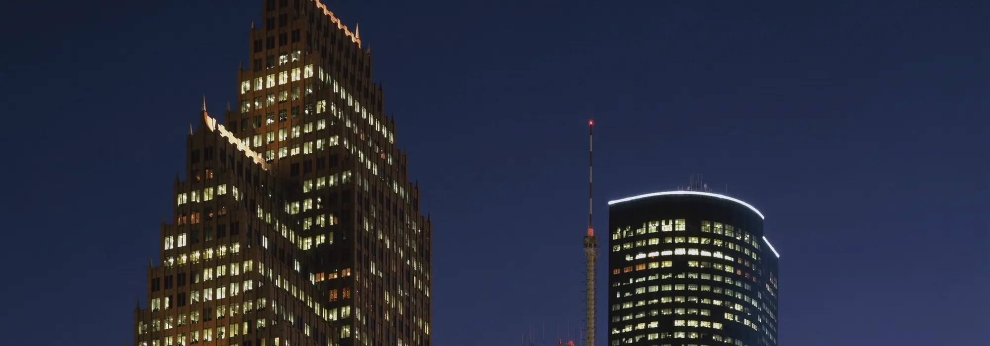 Office towers seen from below against the sky.
